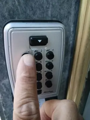 a hand is adjusting the settings of an appliance at Modern-Lux Central 1 Bedroom Condo in Athens