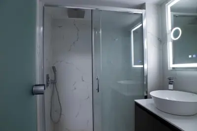 a bathroom with a shower and a sink at Modern-Lux Central 1 Bedroom Condo in Athens