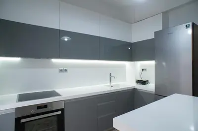 a kitchen with black and white cabinets and a sink at Modern-Lux Central 1 Bedroom Condo in Athens