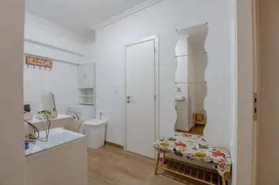 a white kitchen with a bench in a room at Kallithea Gardenspot in Athens