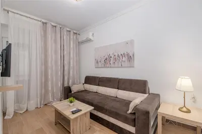 a living room with a couch and a table at Kallithea Gardenspot in Athens