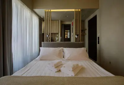a bed with three pillows on it in a bedroom at ATHENS LUX CASA, Urban Eco Suites in Athens