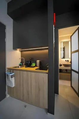 a kitchen with a counter with a sink and a stove at ATHENS LUX CASA, Urban Eco Suites in Athens