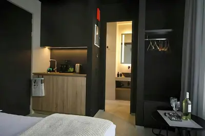 a bedroom with a bed and a table with wine glasses at ATHENS LUX CASA, Urban Eco Suites in Athens