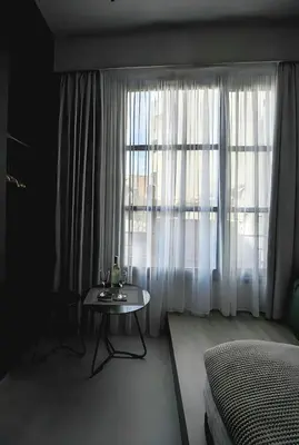a bedroom with a table and a large window at ATHENS LUX CASA, Urban Eco Suites in Athens