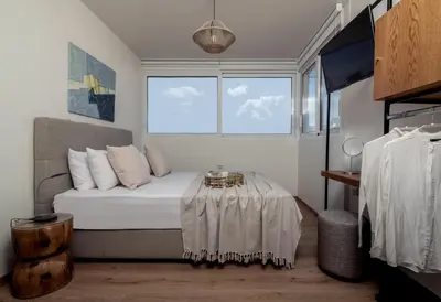 a bedroom with a bed and a table in it at Athens Loft by Phoenix Apartments in Athens