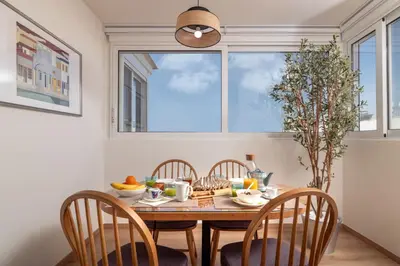 a dining room with a table and chairs and a window at Athens Loft by Phoenix Apartments in Athens
