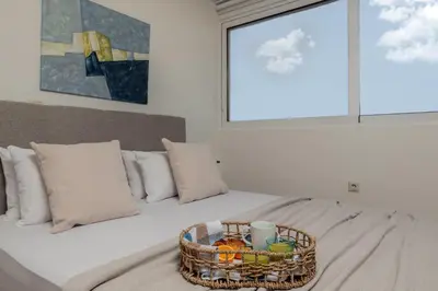a bedroom with a bed with a basket on it at Athens Loft by Phoenix Apartments in Athens