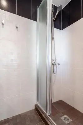 a shower with a glass door in a bathroom at Athens Loft by Phoenix Apartments in Athens