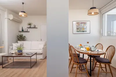 a living room and dining room with a table and a couch at Athens Loft by Phoenix Apartments in Athens