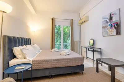 a small bedroom with a bed and a window at Acropolis Stylish 2BR Apartment - Center of Athens in Athens