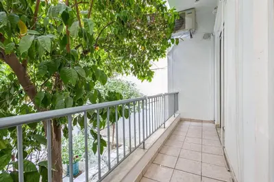 a balcony with a tree and a window at Acropolis Stylish 2BR Apartment - Center of Athens in Athens