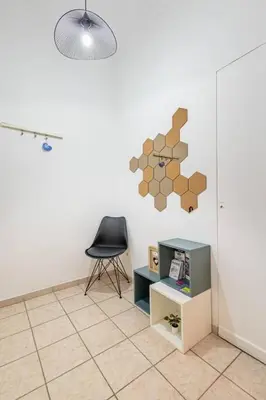 a room with a chair and a table and a wall at Acropolis Stylish 2BR Apartment - Center of Athens in Athens