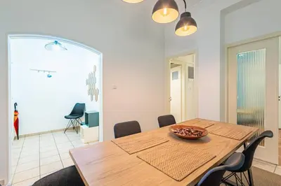 a dining room with a wooden table and chairs at Acropolis Stylish 2BR Apartment - Center of Athens in Athens