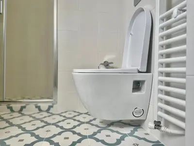 a white toilet in a bathroom with a tile floor at CK apartment view acropole in Athens