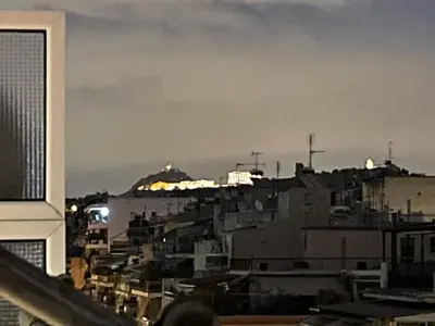 a view of a city at night with buildings at CK apartment view acropole in Athens