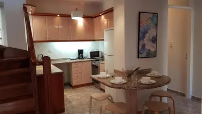 a kitchen with a table and a counter top at Maisonaitte-Athens Center, 4 BD, 2 BATH in Athens