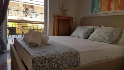 a bedroom with a bed with a dog laying on it at Maisonaitte-Athens Center, 4 BD, 2 BATH in Athens
