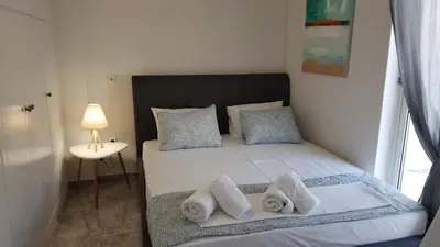 a small bedroom with a bed with towels on it at Maisonaitte-Athens Center, 4 BD, 2 BATH in Athens