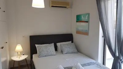 a small bedroom with a bed and a window at Maisonaitte-Athens Center, 4 BD, 2 BATH in Athens