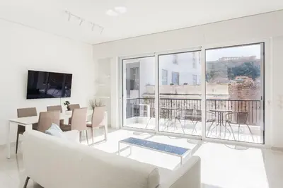 a living room with white furniture and a large window at Athens Observatory Suite in Athens