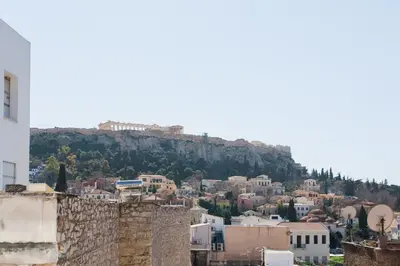 a view of a city with a mountain in the background at Athens Observatory Suite in Athens