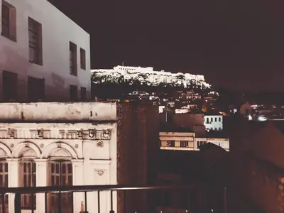 a view of a city at night with buildings at Athens Observatory Suite in Athens