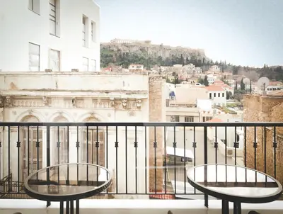 a balcony with two tables and a view of a city at Athens Observatory Suite in Athens