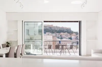 a white living room with a table and chairs at Athens Observatory Suite in Athens