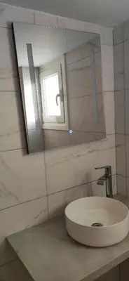 a bathroom with a white sink and a mirror at Nice Apartment Near City Center in Athens