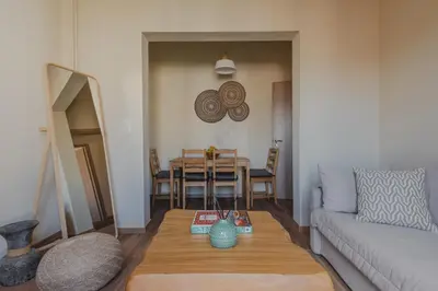 a living room with a table and a couch at Living Stone Aparthotel in Athens