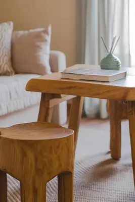 a coffee table with a book on it and a stool at Living Stone Aparthotel in Athens
