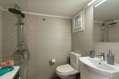 a bathroom with a toilet and a sink at Sirens Athens Apartment in Athens