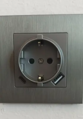 a metal box with a round window on a wall at Sirens Athens Apartment in Athens