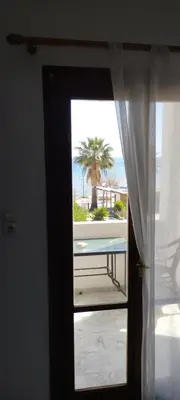 a door to a room with a view of the beach at Παραθαλασσιο στουντιο Μιχαλιας Sea view studio Michalias Νουμερο 8 in Agia Marina Aegina