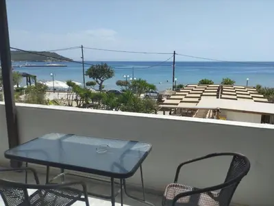 a table and chairs on a balcony with a view of the ocean at Παραθαλασσιο στουντιο Μιχαλιας Sea view studio Michalias Νουμερο 8 in Agia Marina Aegina