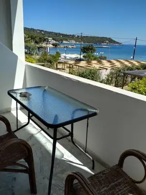 a table on a balcony with a view of the ocean at Παραθαλασσιο στουντιο Μιχαλιας Sea view studio Michalias Νουμερο 8 in Agia Marina Aegina