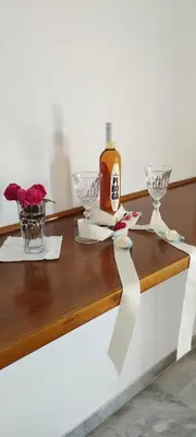 a table with wine glasses and a bottle on it at Παραθαλασσιο στουντιο Μιχαλιας Sea view studio Michalias Νουμερο 8 in Agia Marina Aegina