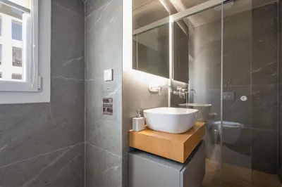 a bathroom with a sink and a glass shower at My Greek Vacations City Apartments in Athens