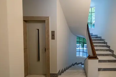 a staircase in a house with white walls and a stair case at My Greek Vacations City Apartments in Athens