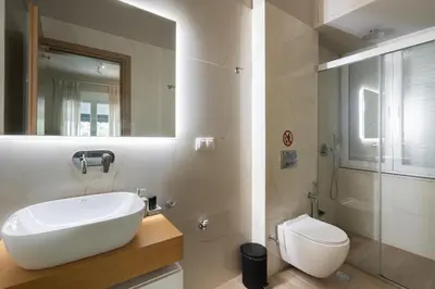 a bathroom with a sink and a toilet at My Greek Vacations City Apartments in Athens