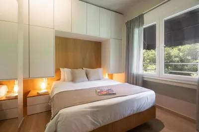 a bedroom with a large bed and a window at My Greek Vacations City Apartments in Athens