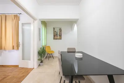 a dining room with a table and chairs at Athens Dreams & Suites Apartments in Athens