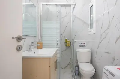 a bathroom with a shower and a toilet and a sink at Athens Dreams & Suites Apartments in Athens