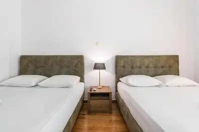two beds sitting next to each other in a room at Victoria Prestige Suites Apartments in Athens