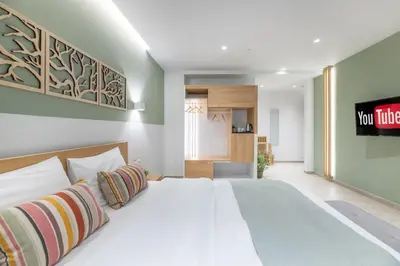 a bedroom with a bed and a tv on the wall at STARLA STUDIOS in Athens