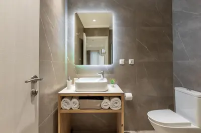 a bathroom with a sink and a toilet and a mirror at STARLA STUDIOS in Athens