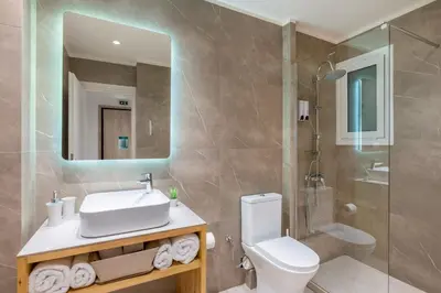 a bathroom with a sink and a toilet and a shower at STARLA STUDIOS in Athens