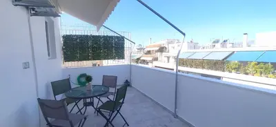 a balcony with a table and chairs on a building at Experience a nice view appartment-heart of Athens in Athens