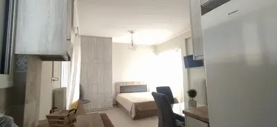 a bedroom with a bed and a table in a room at Experience a nice view appartment-heart of Athens in Athens
